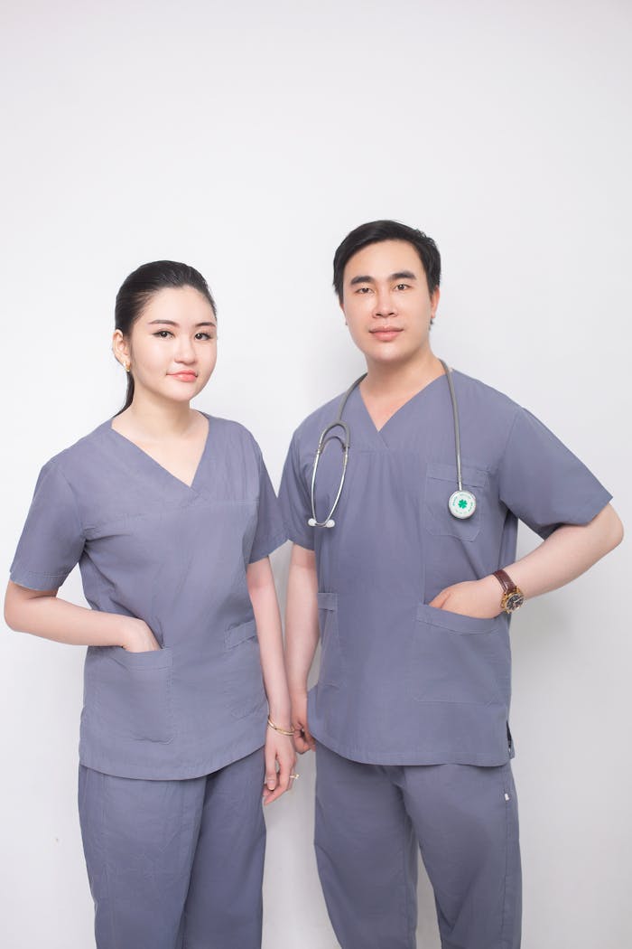 hero-img Male and female healthcare professionals in grey scrubs with a stethoscope.