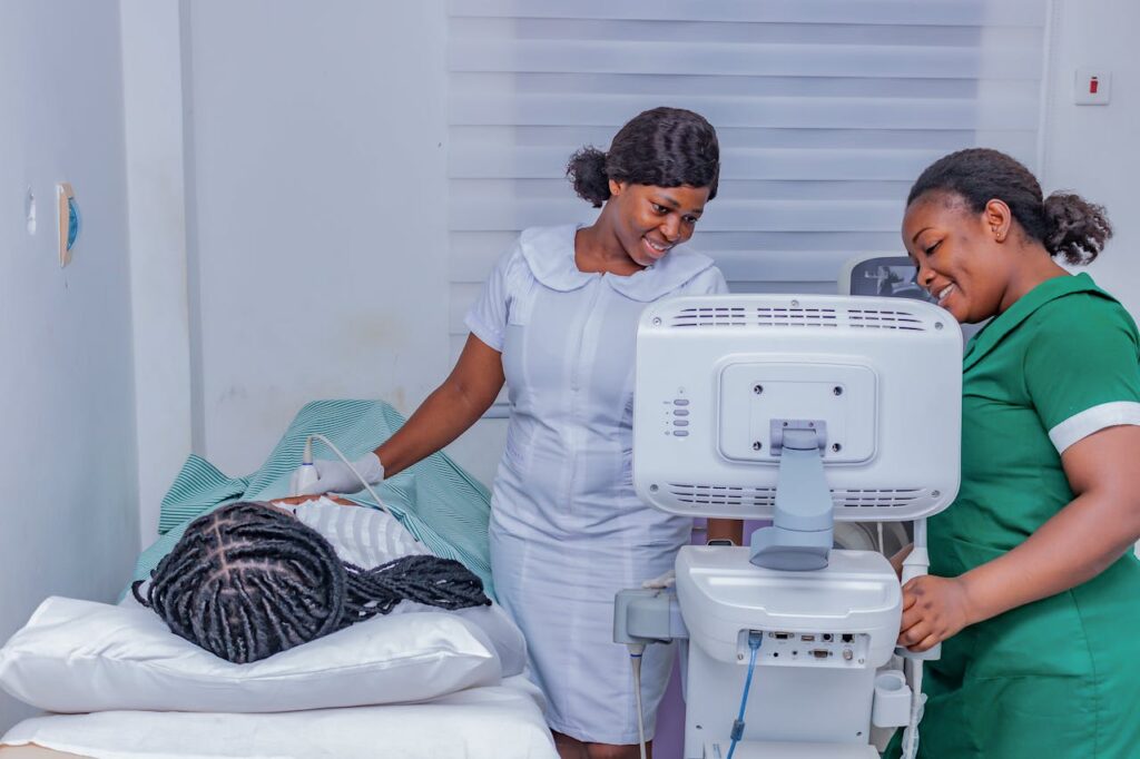 pexels photo 29941469 Smiling healthcare professionals performing an ultrasound examination in a clinical setting.